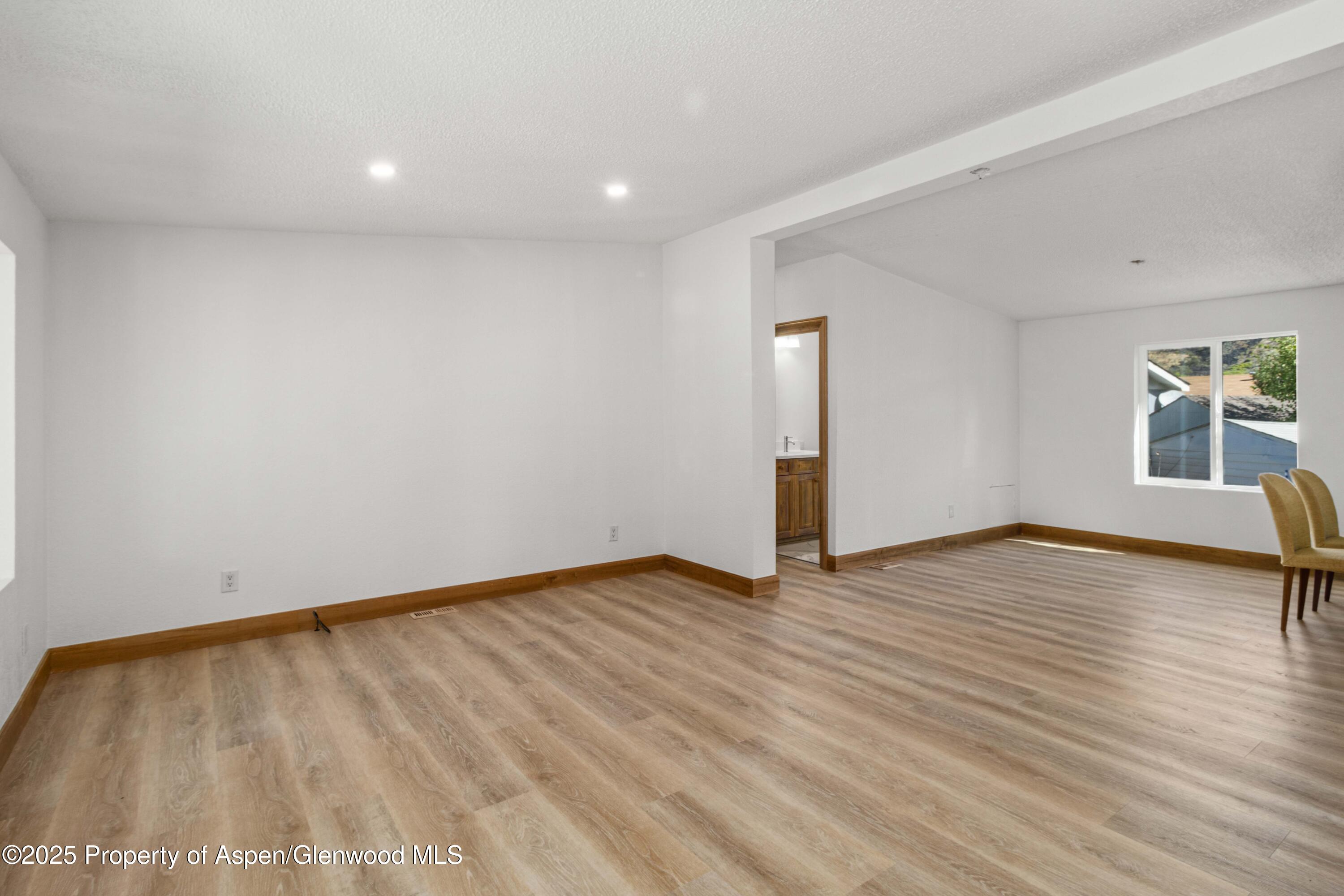 161 James Circle El Jebel, CO 81623 - Photo 8 of 24 a view of an empty room with wooden floor and a window