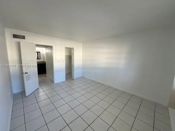 a view of an empty room and chair