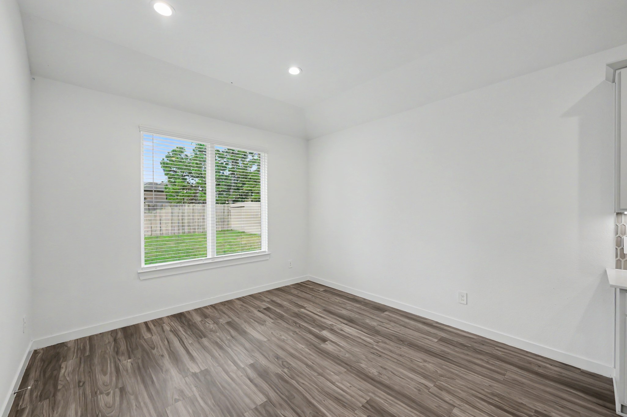 14162 Primrose Ridge Lane Conroe, TX 77384 - Photo 21 of 48 Bright, open room with elegant wood flooring and large window offering views of the lush backyard.