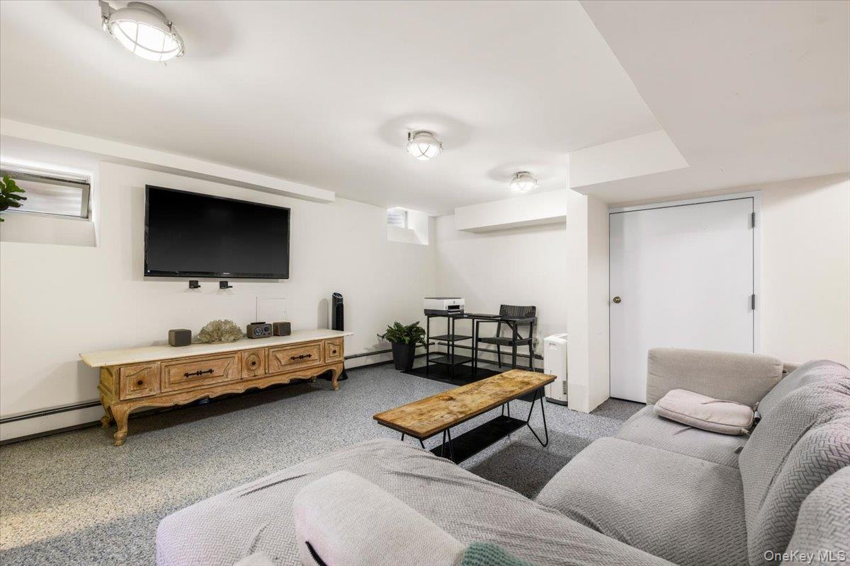 620 Timpson Street Pelham, NY 10803 - Photo 23 of 32 a living room with furniture and a flat screen tv