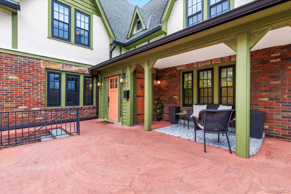 620 Timpson Street Pelham, NY 10803 - Photo 28 of 32 a view of a building with furniture and floor to ceiling window