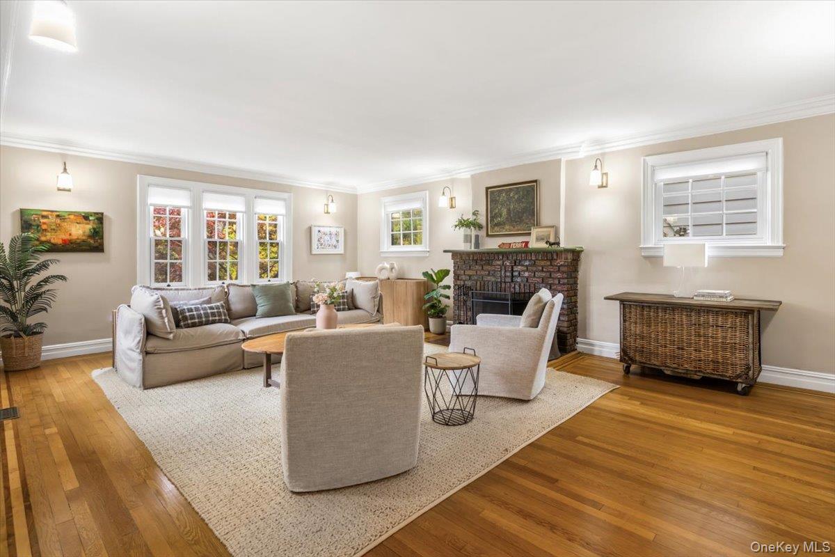620 Timpson Street Pelham, NY 10803 - Photo 5 of 32 a living room with furniture a fireplace and a flat screen tv