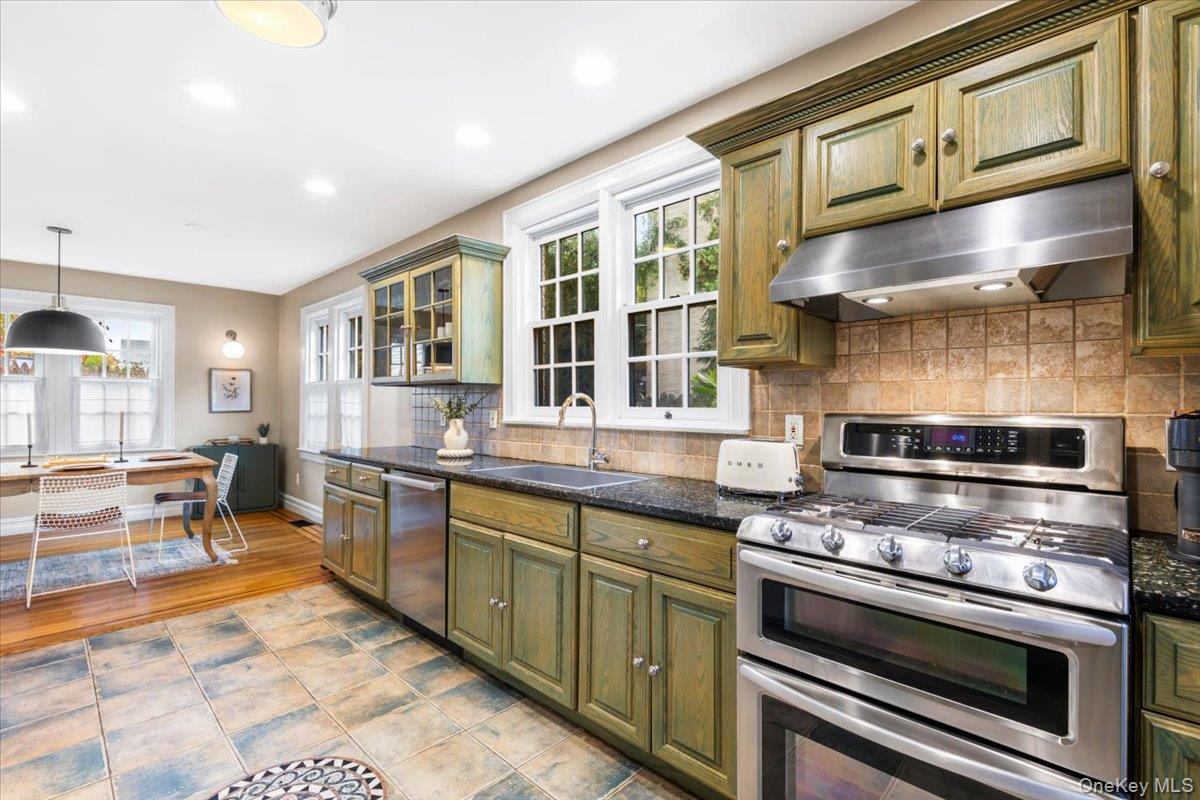 620 Timpson Street Pelham, NY 10803 - Photo 7 of 32 a kitchen with stainless steel appliances granite countertop a stove and a sink