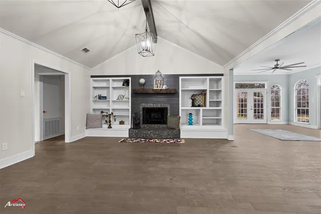 a view of an empty room with a fireplace and a window