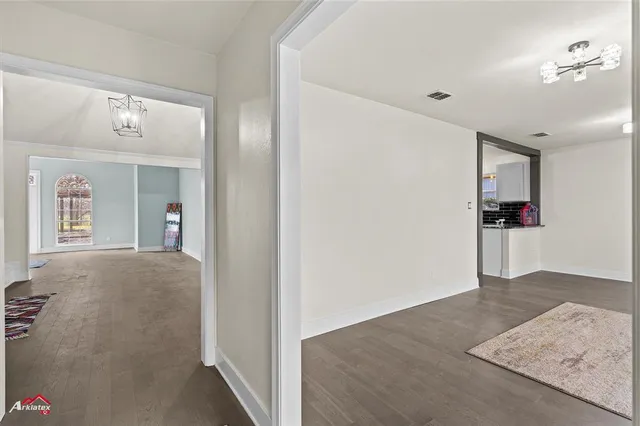 a view of hallway with livingroom and stairs