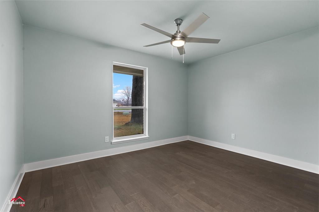 5524 Hickory Ridge Drive Bossier City, LA 71111 - Photo 16 of 17 an empty room with wooden floor chandelier and windows