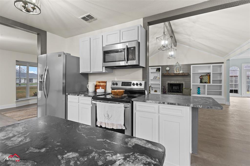 5524 Hickory Ridge Drive Bossier City, LA 71111 - Photo 4 of 17 a kitchen with stainless steel appliances granite countertop a refrigerator a stove top oven a sink and dishwasher