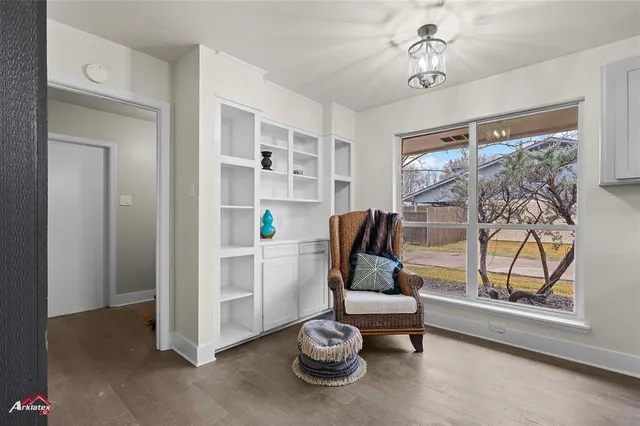 a living room with furniture a window and a chandelier