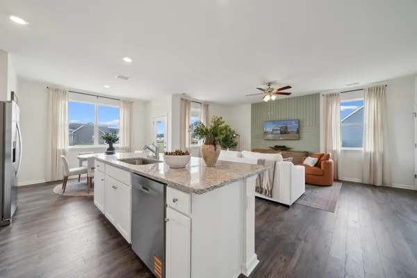 a open kitchen with stainless steel appliances granite countertop a lot of counter space and wooden floor