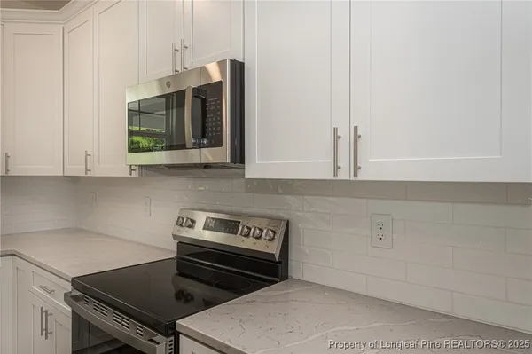 a kitchen with a stove and a microwave