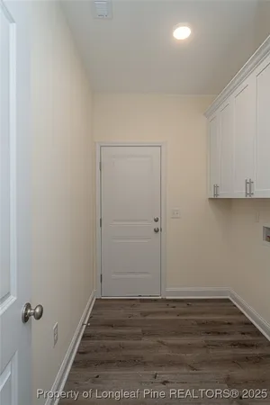 a view of a room with wooden floor