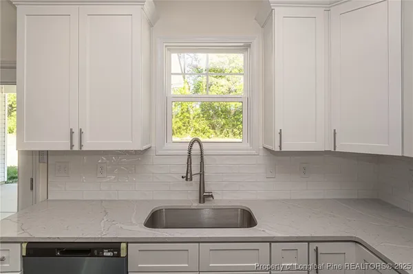 a kitchen with a sink and window