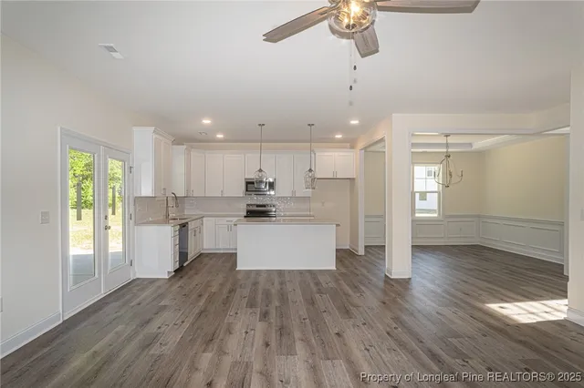 a large kitchen with a large window appliances and cabinets