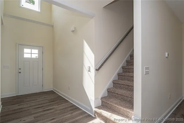 a view of entryway and hall with wooden floor
