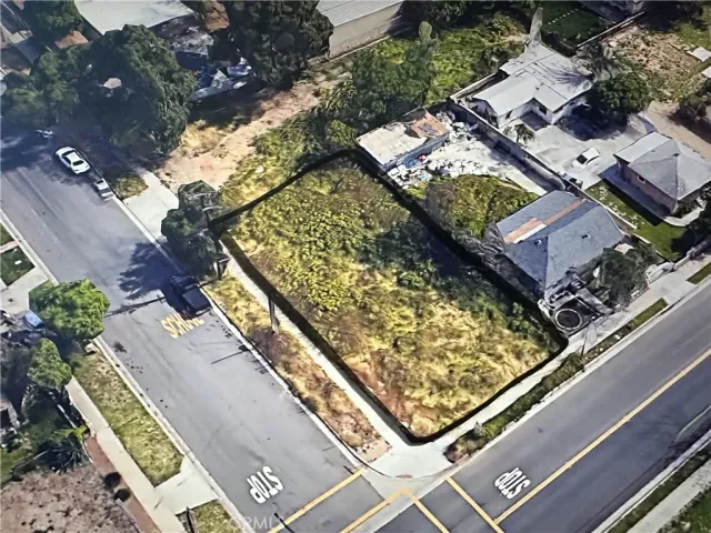 an aerial view of a residential houses with yard