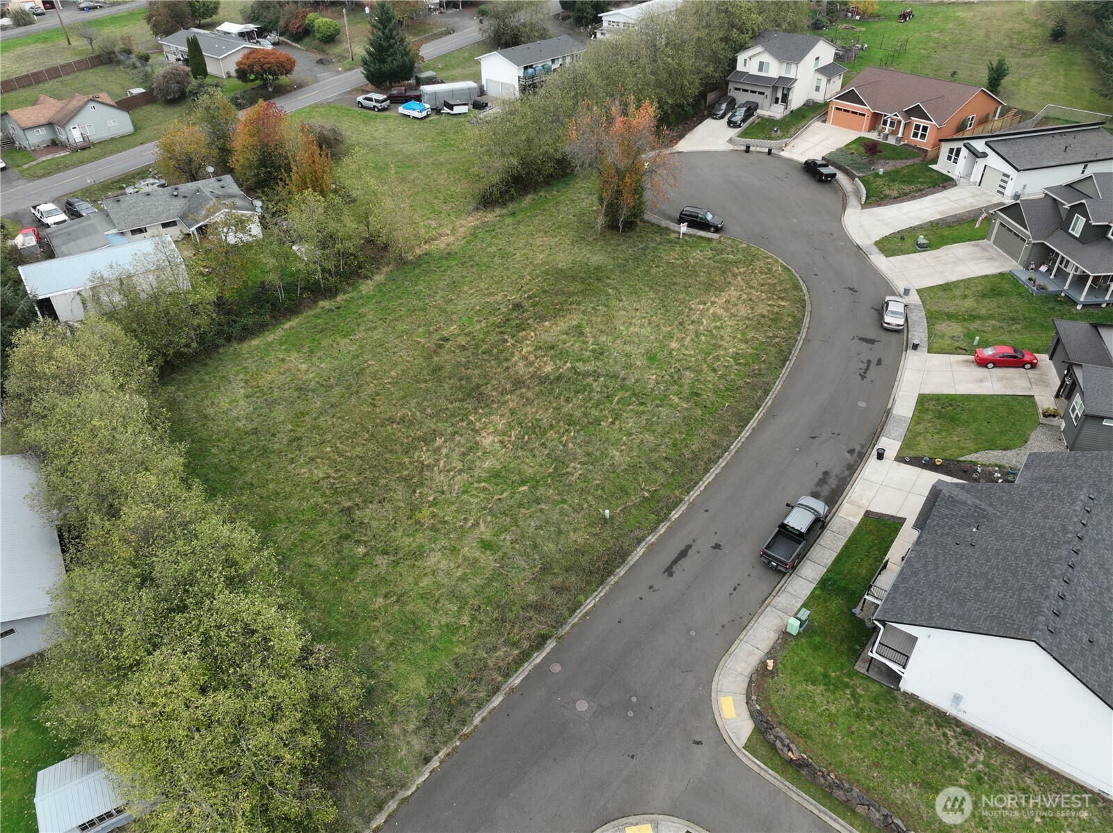 an aerial view of a house with a yard and mountain