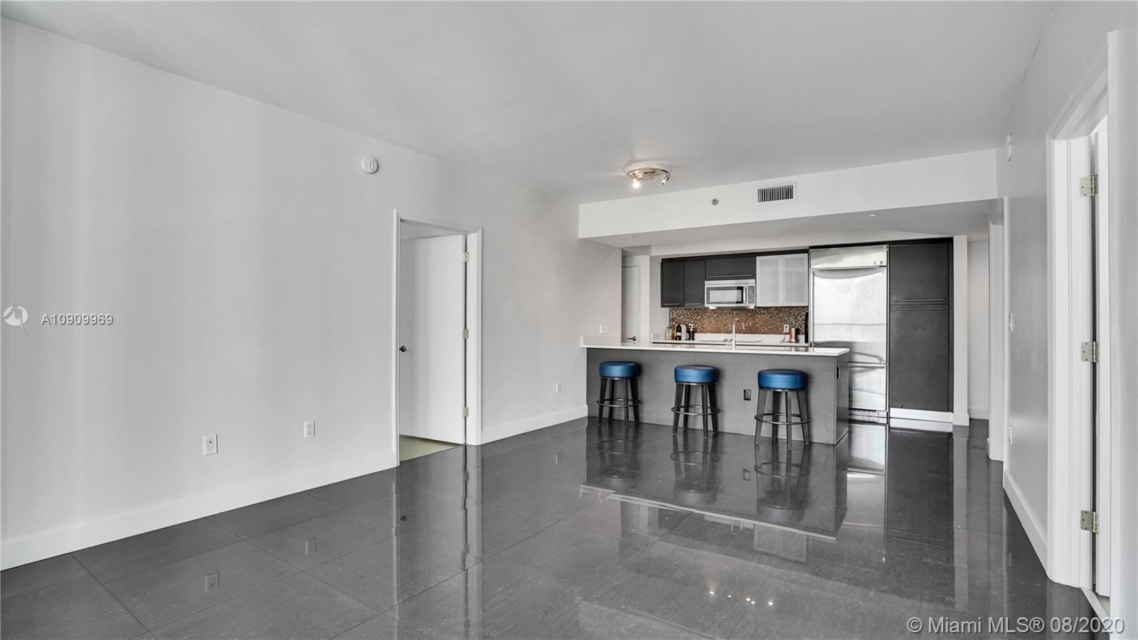 55 Southeast 6th Street, Unit 1903 Miami, FL 33131 - Photo 11 of 26 a view of a dining room with furniture
