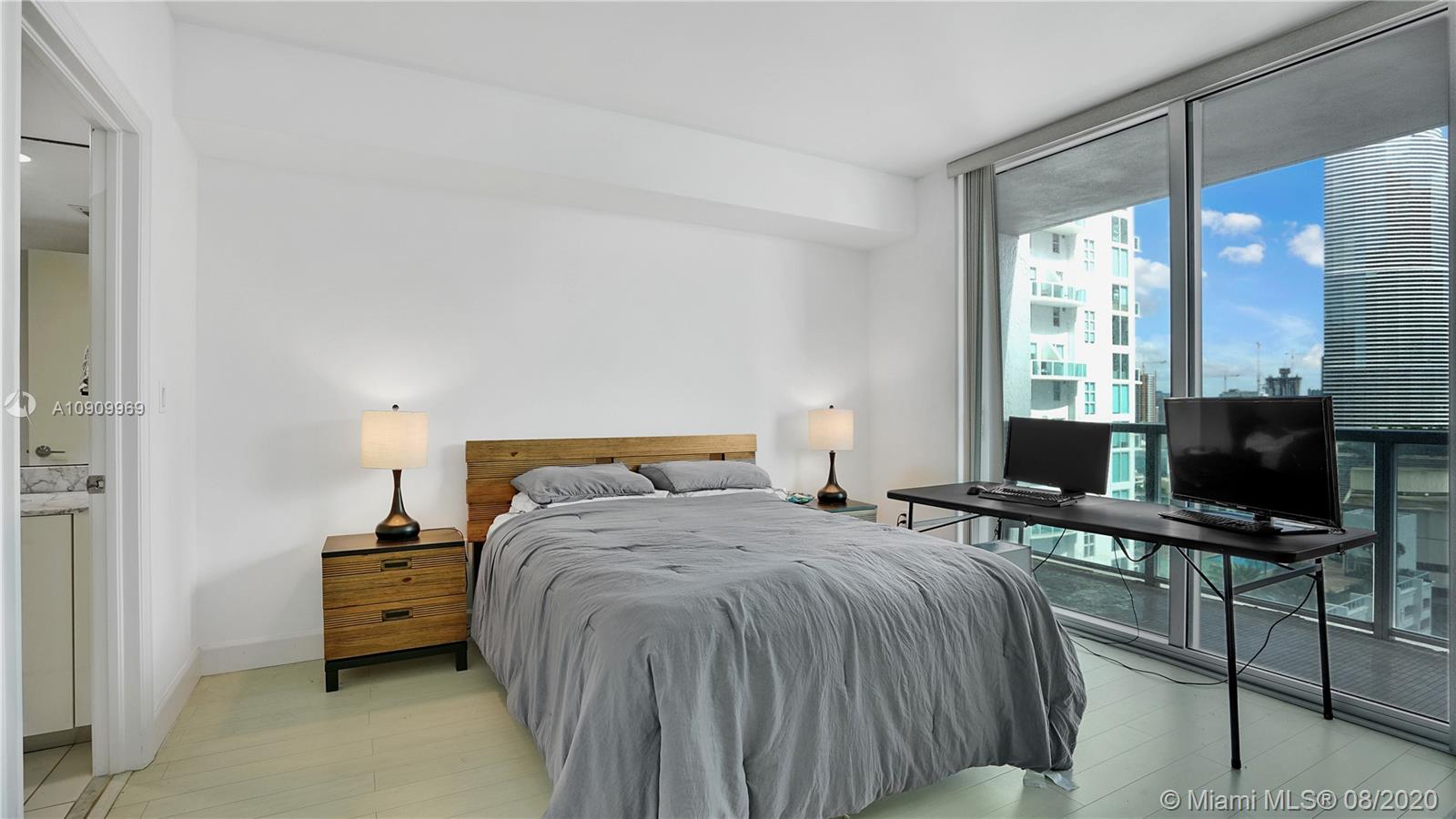 55 Southeast 6th Street, Unit 1903 Miami, FL 33131 - Photo 13 of 26 a bed room with a bed and a window