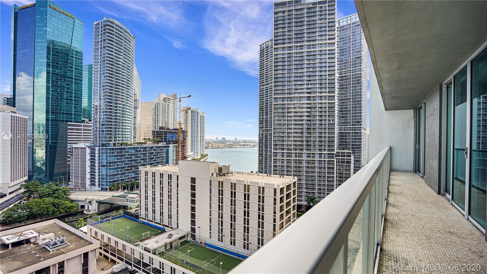 55 Southeast 6th Street, Unit 1903 Miami, FL 33131 - Photo 18 of 26 a balcony with two chairs and a potted plant