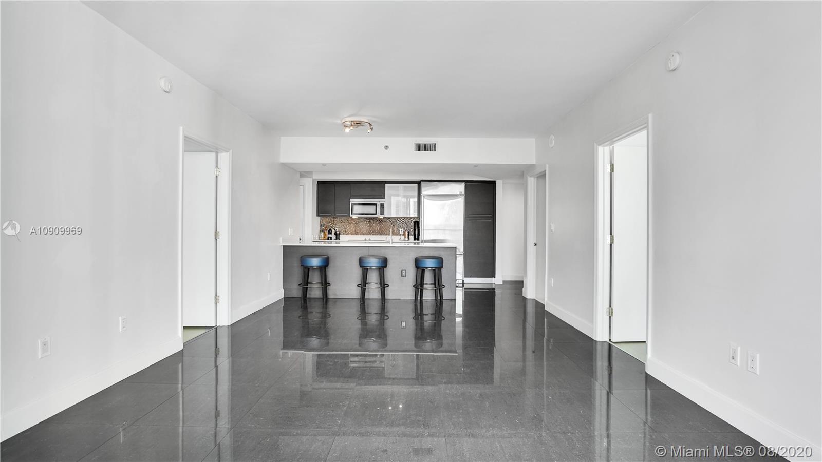 55 Southeast 6th Street, Unit 1903 Miami, FL 33131 - Photo 4 of 26 a view of kitchen with furniture and window