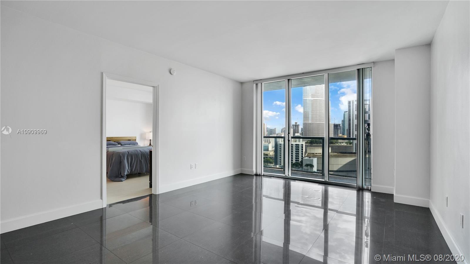 55 Southeast 6th Street, Unit 1903 Miami, FL 33131 - Photo 5 of 26 a view of a big room with wooden floor and windows