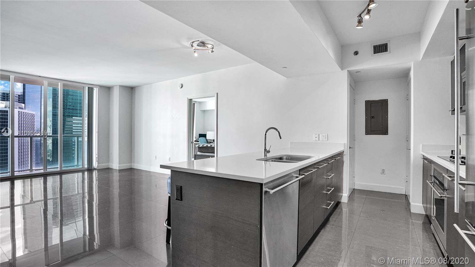 55 Southeast 6th Street, Unit 1903 Miami, FL 33131 - Photo 8 of 26 a kitchen with stainless steel appliances a sink and a refrigerator