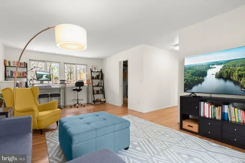 a living room with furniture and a book shelf