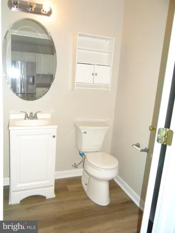 a white toilet sitting next to a bathroom sink