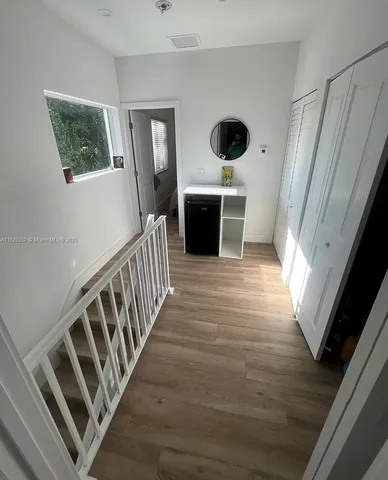 a view of an entryway with wooden floor