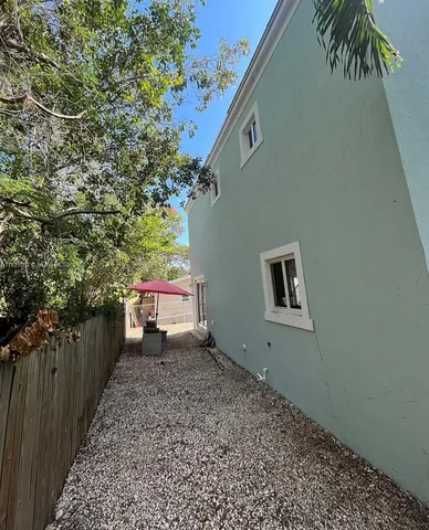 a view of a pathway of a house with a yard
