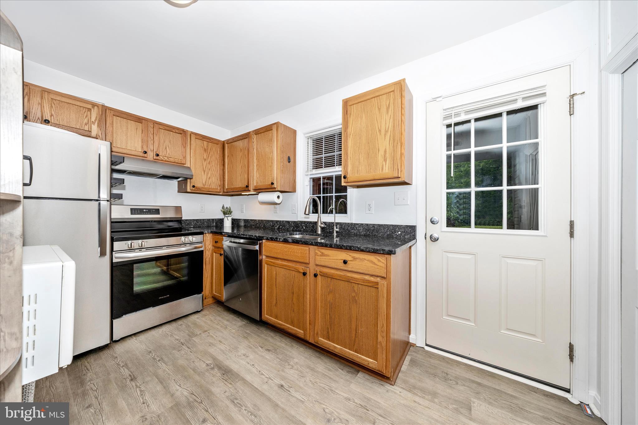916 Harwood Road Hagerstown, MD 21740 - Photo 14 of 52 a kitchen with stainless steel appliances granite countertop a stove a sink and a refrigerator