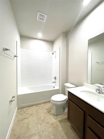 a bathroom with a sink a toilet a mirror and bathtub