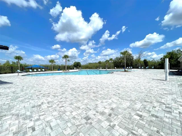a swimming pool with some trees in the background