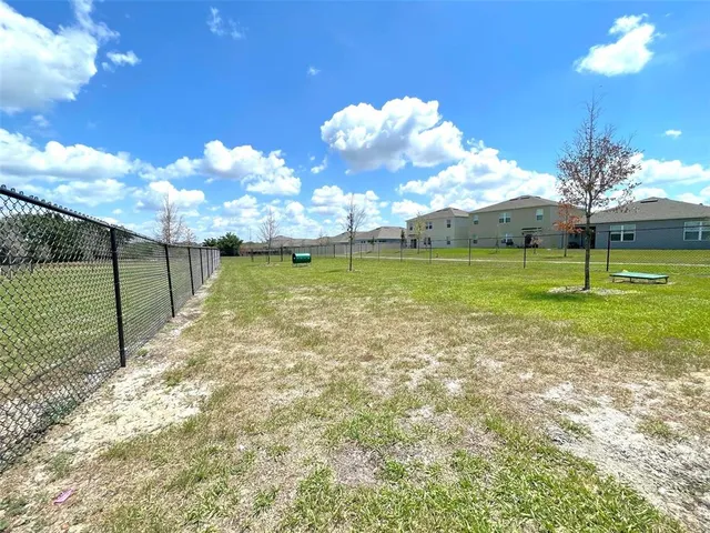 a view of a swimming pool with outdoor seating and plants