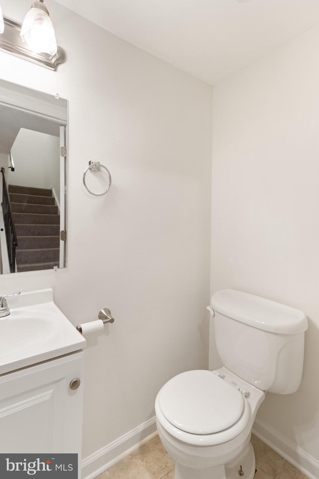 8581 Chester Grove Court Springfield, VA 22153 - Photo 36 of 38 a white toilet sitting next to a bathroom sink