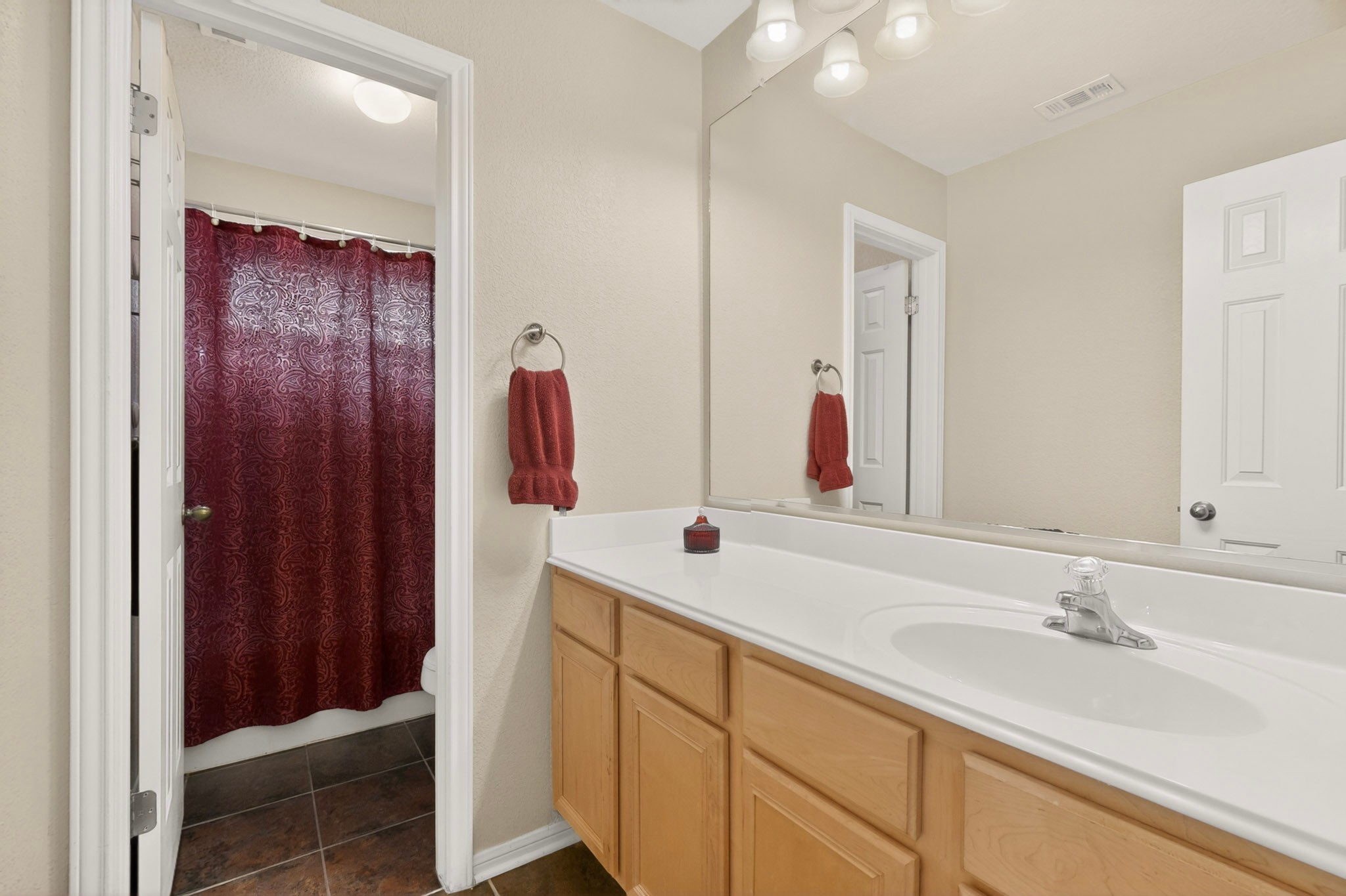 905 Victoria Ridge Drive Pflugerville, TX 78660 - Photo 21 of 32 A well-appointed hall and secondary bedroom bathroom vanity features a broad counter and ample storage.