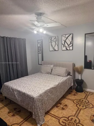 a bedroom with a bed and a mirror