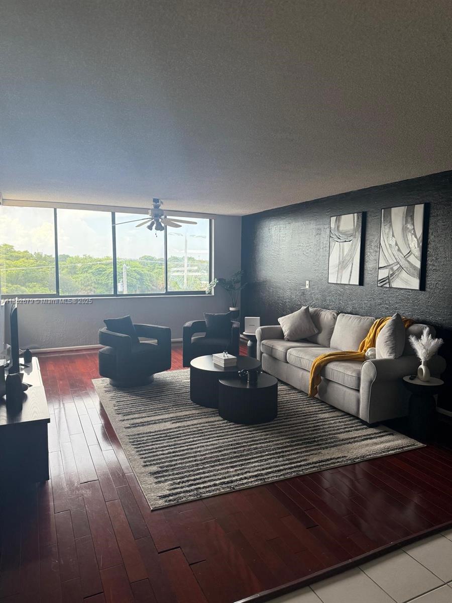 8040 Hampton Boulevard, Unit 512 North Lauderdale, FL 33068 - Photo 7 of 18 a living room with furniture and a large window