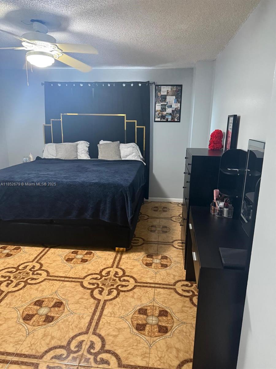 8040 Hampton Boulevard, Unit 512 North Lauderdale, FL 33068 - Photo 9 of 18 a bedroom with a bed and a dresser