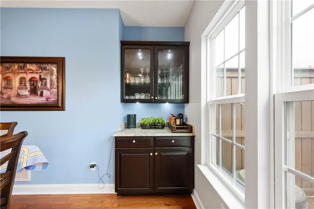 a view of a kitchen with stainless steel appliances wooden floor and a window