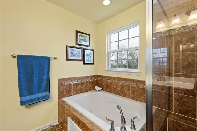 a bathroom with a tub and shower