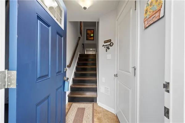 a view of a hallway with wooden floor and entryway