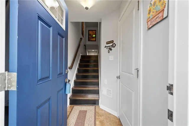 a view of a hallway with wooden floor and entryway