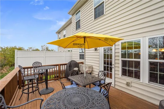 a view of a patio with a table and chairs under an umbrella