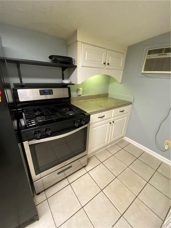 140 Line Street Buford, GA 30518 - Photo 25 of 31 a kitchen with white cabinets and appliances
