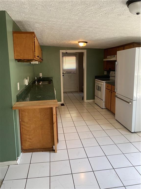 140 Line Street Buford, GA 30518 - Photo 6 of 31 a kitchen with stainless steel appliances granite countertop a refrigerator and a stove