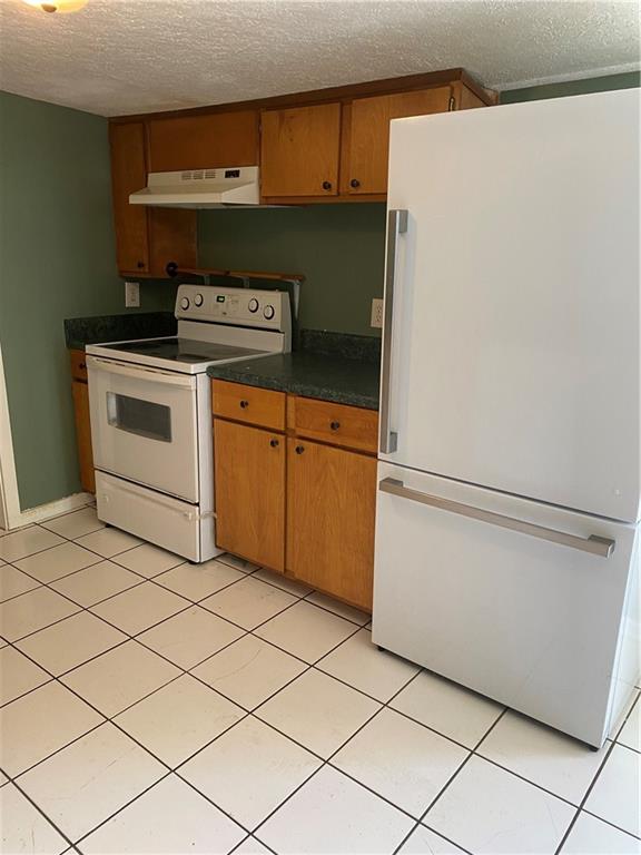 140 Line Street Buford, GA 30518 - Photo 7 of 31 a kitchen with cabinets and white appliances