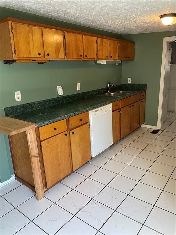 140 Line Street Buford, GA 30518 - Photo 8 of 31 a kitchen with stainless steel appliances granite countertop a sink and cabinets