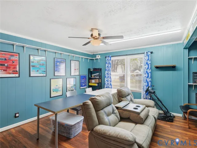 a living room with furniture a ceiling fan and a window
