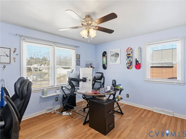 a view of a workspace with furniture and a window